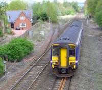 A Glasgow Central - Carlisle service approaching Dumfries station on 3 May passes the former junction for the Stranraer line. The trackbed of the old <I>Port Road</I> has been converted to a walkway/cycleway just beyond the trees and follows the route as far as Cargenbridge on what is now known as The Maxwelltown Railway Path. [See image 25379]<br><br>[Brian Smith 03/05/2010]