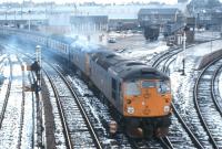 Headed by a pair of Class 26 locomotives, a northbound special accelerates away from Inverness's Rose Street curve on a winter's day in the early 1970s.<br><br>[Frank Spaven Collection (Courtesy David Spaven) //]