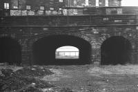 Standing on the east side of Gardner's Crescent looking along the Caledonian trackbed in 1972 [see image 29568]. Directly behind the camera was the site of the original Lothian Road station (1848), with the later Princes Street station (1870) built alongside and to the north. By this time all track had been lifted and the area cleared, with thoughts starting to turn to the possibility of converting the old trackbed into a road...  <br><br>[Bill Jamieson //1972]