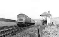 A Brush type 4 with a diverted southbound train on the Waverley route on Sunday 9 June 1968 passes Whitrope Siding signal box.<br><br>[Bruce McCartney 09/06/1968]