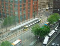 Piccadilly Gardens tram station has recently been rebuilt with a new full length canopy. In this view from nearby City Tower new 3000 series tram 3002 rolls in on an Eccles service as a sister unit heads for Piccadilly Station. [See image 22642] for a similar view taken in early 2009<br><br>[Mark Bartlett 09/07/2010]