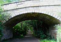 Leith North's original connection with Waverley (or Canal Street) was<br>
via the line through Scotland Street tunnel.The 'main' line continued to Granton Harbour, and the Junction for the Leith branch was at Warriston. Here's the trackbed of the branch looking towards Warriston on 12 July. Fans of the spectacularly dull central Scottish town of Stoneybridge, brought to you by the cult TV comedy show 'Absolutely' in the early 1990s, will have no difficulty in recognising the model for the stoney bridge itself, as seen in the town council's promotional vide-o (it's vidayo!) along with the the shots of Breich's only real street and the since-demolished horrible clock in Tranent.<br>
<br><br>[David Panton //]