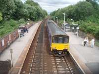 Hindley, looking towards Manchester, sees 150136 call on a Southport service. The bridge in the distance marks Crow Nest Junction where the Bolton and Walkden lines split. To the right of the picture the overgrown area is the trackbed of the lifted lines on this former four track railway. <br><br>[Mark Bartlett 09/07/2010]