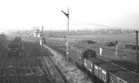D8120 approaches Niddrie West Junction with an unfitted freight from Millerhill, (possibly the 14.56 to Mossend) on 4 February 1970. Beyond and to the right of the signal box is the embankment that carried a section of the original 1835 Edinburgh & Dalkeith Railway route towards Leith (closed in 1859).<br>
<br><br>[Bill Jamieson 04/02/1970]