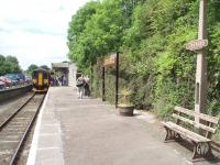 WR Brown <I>totems</I> and <I>running in board</I> are a nice touch on the Looe branch station at Liskeard (and the other stations on the Looe line), as is the GWR bench in the foreground. That said, no train used on the branch would ever reach this far down the platform. In this scene 153368 has just arrived from Looe, to which it will shortly return with another healthy complement of passengers. <br><br>[Mark Bartlett 15/06/2010]