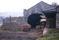More than 100 years after closure, Newtyle (Old) station building survives in agricultural use in October 1974. The original Dundee-Newtyle route included three inclined planes which required stationary steam engines to haul the trains uphill. These steep sections were bypassed by three new deviation routes, including the section which led to the closure of Newtyle (Old) and the associated Hatton Incline in 1868.<br><br>[Frank Spaven Collection (Courtesy David Spaven) /10/1974]