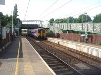 A Blackpool to Liverpool service, formed by 156464, calls at Euxton Balshaw Lane, which reopened in 1998, twenty nine years after it first closed. The original station had four platforms, that were cleared after closure [See image 29820] but the new station has only slow line platforms, complete with huge access ramps.  <br><br>[Mark Bartlett 15/07/2010]