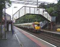 As at quite a few other places it was the name chosen for the station that gave the name to the community which built up around it. Nobody seems sure where the railway got 'Bearsden' from.  If it was a jocular reference to a bear's den then it didn't stop the area becoming one of Glasgow's smarter 'pan loaf' suburbs.  A 6-car Juniper pulls in for Milngavie on 14 July.<br>
<br><br>[David Panton 14/07/2010]