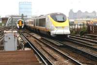 A Brussels - Waterloo <I>eurostar</I> passes a 'South Eastern' emu on a Victoria - Orpington service just north of Wandsworth Road station in July 2005. To the left is Factory Junction giving access to the LSWR routes and the West London Line via Clapham Junction. <br><br>[John Furnevel 21/07/2005]