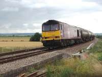 In 2010, before the <I>Super 60</I> refurbishment programme, there were still a few Class 60s working hard on the mainline and here 60040 <I>The Territorial Army Centenary</I>, in <I>Army</I> livery, heads a lengthy oil train north at Tredington level crossing between Cheltenham and Aschurch.<br><br>[Mark Bartlett 17/07/2010]