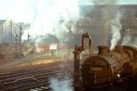 Sunshine and steam at Edinburgh Princes Street station on Monday 2 November 1964. Black 5 no 45127 eases empty coaching stock away from platform 1, while Fairburn 2-6-4 tank no 42058 waits alongside the water column on the south side of the station. The photograph was taken from the steps of the signal box.<br><br>[Frank Spaven Collection (Courtesy David Spaven) 02/11/1964]