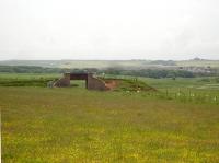 Former overbridge across the trackbed of the railway alongside the A975 at grid ref NK103374 looking south west towards Cruden Bay.<br><br>[David Pesterfield 26/06/2010]