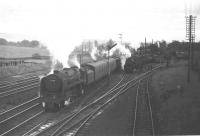 Scene at Beattock in fading light around 1965 as Clan Pacific no 72008 <I>Clan MacLeod</I> takes on banking assistance with a lengthy parcels train. Meantime a Black 5 bides its time in the loop with a northbound freight.<br><br>[Robin Barbour collection (Courtesy Bruce McCartney) //1965]