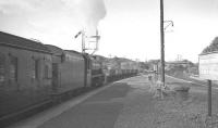 Black 5 no 45084 of Stirling shed prepares to leave Connel Ferry in September 1960 on the last leg of its journey to Oban. The board on the right reminds passengers to alight here for the connecting service to Ballachulish [see image 29723]. The train is thought to be the 6.50am ex-Princes Street / 7.55am ex-Buchanan Street. <br><br>[K A Gray 09/09/1960]