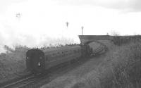 One of Hawick shed's BR standard class 2 locomotives with the 11.24am St Boswells - Kelso train shortly after leaving Kelso Junction on 9 November 1963. The train is about to pass under the bridge carrying the A699 road. <br><br>[Robin Barbour Collection (Courtesy Bruce McCartney) 09/11/1963]