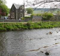 View north across the Tweed at Peebles in May 2010 over the section once spanned by the railway bridge carrying the NB/Caley link line. Part of the abutment on the north shore still survives, albeit now supporting a brick garden wall, while the torpedo shaped supports for the old bridge piers can be seen in the river. The unusual looking 'half-house' would appear to have been the subject of major modifications to make way for the line in 1864, although an extension has been added since 1959 when the line closed.<br><br>[John Furnevel 21/05/2010]