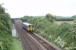 A Cumbrian Coast service passes under the Carnforth Ironworks Tramroad bridge that is now used to carry a private farm road [See image 30144]. 153378 is running between Silverdale and Carnforth.<br><br>[Mark Bartlett 26/06/2010]