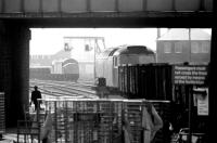 A class 47 takes a freight south through Rotherham Masborough station in May 1981 on the Sheffield avoiding line. Held in the down loop is a class 40 with a ballast train. <br><br>[John Furnevel 04/05/1981]