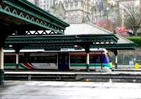 West end of Waverley on 28 December 2004 with a Queen Street shuttle at the platform. In the background preparations are underway in Market Street for the Hogmanay celebrations.  <br><br>[John Furnevel 28/12/2004]