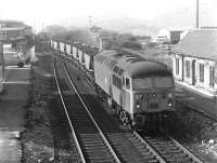 Looking south from Station Road, Shirebrook, in May 1980 as 56004 reverses coal empties through the old station. The 1966 Shirebrook West diesel depot (41J) stands in the left background.<br><br>[John Furnevel 05/05/1980]