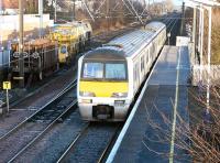 A class 322 EMU on a North Berwick - Edinburgh service arriving at Prestonpans in bright winter sunshine on 29 January 2003. The points to the left of the train are for the line into Cockenzie sidings and power station.<br><br>[John Furnevel 29/01/2003]