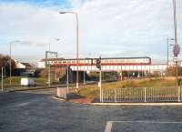 A Glasgow Central - Edinburgh Waverley via Shotts train crossing the B701 on the approach to Wester Hailes station in November 2002.<br><br>[John Furnevel 22/11/2002]