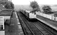 An unidentified type 2 with a westbound parcels train passing through the old Slateford station in October 1980, prior to demolition of the platform buildings.<br><br>[John Furnevel 06/10/1980]