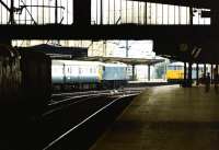 Looking south through Carlisle station in July 1976 as an up WCML train calls at platform 4 behind a class 86 locomotive, while another waits on the centre road.<br><br>[John Furnevel 14/07/1976]