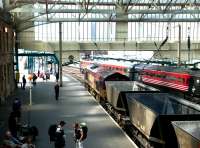 An EWS class 66 takes coal empties north through Carlisle station on 13 May 2003.<br><br>[John Furnevel 13/05/2003]