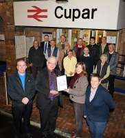 ScotRail external relations manager John Yellowlees makes the presentation to Councillor Margaret Kennedy at Cupar station on 14 November 2011. They are joined by staff members John Mullen and Hannah Cooper along with representatives of the 'Friends of Cupar Station' [see News item].<br><br>[First ScotRail 14/11/2011]