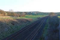 The site of Lindal station, between Ulverston and Dalton, closed in 1951. In this 2014 view west towards Dalton the tracks diverge slightly but this is to pass under a two arch bridge. The long removed platforms stood on either side of the line. [Ref query 3859]<br><br>[Mark Bartlett 10/03/2014]