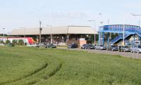 Leuchars Station looking west from the A919 road in May 2005. The cars in the picture are minicabs - a spacious free station customer car park is provided off to the right at the end of the footbridge. <br><br>[John Furnevel 19/05/2005]