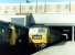 An eastbound freight passing through Ealing Broadway on 2 September 1970 on its way to join the North London Line at Acton Wells Junction. The locomotive is Stratford based Brush Type 4 no 1563 and the freight is passing the Greenford branch DMU awaiting its departure time at the adjacent platform.<br><br>[John Furnevel 02/09/1970]