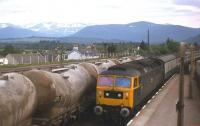 <I>The Clansman</I> draws into Aviemore on its way north in the late 1970s, passing cement empties from Inverness held in the loop waiting to continue their onward journey to Millerhill. <br><br>[Frank Spaven Collection (Courtesy David Spaven) //]