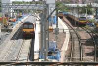 Progress at Airdrie on 27 July 2010, with track now laid through the under-construction Bathgate platform. A Helensburgh train is leaving on the left with a following service to Balloch waiting in the bay.<br><br>[John Furnevel 27/07/2010]