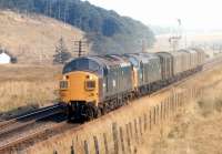 A short down parcels train between Grantshouse and Penmanshiel tunnel in August 1971, probably the 08.35 from Doncaster to Edinburgh. This was due to pass Grantshouse at 15.30 but did not do so until 16.50 suggesting a failure of the train engine, class 40 No. 256. The class 37 is No. 6762, a Gateshead engine, which was presumably commandeered from a trip working (9B22) in the Newcastle area to assist.<br><br>[Bill Jamieson 19/08/1971]