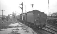 <I>Scottish Rambler No 5</I> arriving at the former Ardrossan North station on 10 April 1966. B1 4-6-0 no 61342 of Eastfield shed has just brought the train  back from a visit to Montgomerie Pier. The line over the level crossing below the footbridge provided a link with the G&SW line to Winton Pier. Part of the large Shell refinery and its associated sidings can be seen off to the right.<br><br>[K A Gray 10/04/1966]