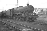 Much of the visiting Blackpool excursion traffic during the summer months used the stabling sidings and turntable at Bloomfield Road, which was preferred by crews, being quicker than going through the main shed procedures at Blackpool Central and thus allowing more time for <I>relaxation</I> between turns. The photograph shows Jubilee no 45710 <I>Irresistible</I> of Manchester's Newton Heath shed carrying an excursion headcode standing in Bloomfield Road sidings in 1962. The floodlights of Blackpool FC's Bloomfield Road ground can be seen in the background. [See image 30224 for the scene fifty years later].<br><br>[K A Gray 23/09/1962]