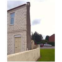 The 'squinty house' in Seedhill Road, to the west of Hawkhead station. The view shows its peculiarly-angled gable, which came about as a result of the now-removed embankment of the former Paisley & Barrhead Railway that ran along the line of the boundary wall. View south on 2 August 2010.<br><br>[Colin Miller 02/08/2010]