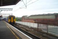 The long trainshed at Manchester Mayfield, and the vehicle access ramp that runs alongside, can clearly be seen from Platform 14 at Piccadilly as 156468 runs in on a Liverpool service. Mayfield was only open to passengers from 1910 to 1960, although it continued as a parcels depot for much longer.<br><br>[Mark Bartlett 09/07/2010]