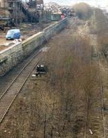 View along the loading spur at the 'European Metal Recycling' scrap plant at Laisterdyke, Bradford, on 26 February 1998. Immediately to the right is the overgrown run round loop on the former avoiding line, with the running lines beyond. [See image 27177]<br><br>[David Pesterfield 26/02/1998]