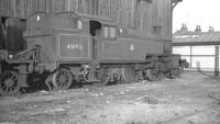 Stanier 2-6-2T no 40198 stands on the former no 9 road at Wigan shed (ex-L&YR) in April 1962. Roads 9-14 of the shed were roofless by this time. The shed, coded 27D, finally closed in April 1964 and was demolished in 1966. 40198 was withdrawn from Southport shed in the summer of 1962 and cut up at Campbells of Airdrie the following year. <br><br>[K A Gray 15/04/1962]