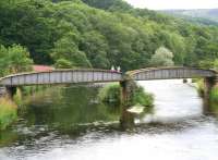 Two young girls pause on a bridge over a river on their Sunday morning walk to share a can of ginger beer and a <I>Wispa</I> chocolate bar (I was behind them in the shop) on 8 August 2010. The river is the Tweed and the bridge once carried the line north west from Cardrona station (just off picture to the left) towards Peebles.<br><br>[John Furnevel 08/08/2010]