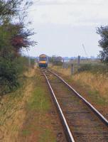 Approaching Berney Arms in the Norfolk Broads in September 2009 by one of the 4 methods available, the other 3 being by foot, by boat (on the River Yare) and by parachute. The single short-platform halt was named after the landowner who originally sold the land to the Norwich & Yarmouth Railway on condition they built a station there. Trains stop on request and only during daylight hours as there is no lighting at the station - or anywhere near it. Berney Arms remains one of the remotest stations in England. [With thanks to Messrs Morgan, Gibb and Bartlett] <br><br>[Ian Dinmore /09/2009]
