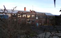 The former rail-served paper mill alongside the Rosyth Dockyard branch at Inverkeithing in January 2010. For generations rail travellers have looked down on this confidently-lettered frontage from high above on Jamestown viaduct. No doubt many of them have mused, like me, that with the benefit of hindsight 1914 was not an ideal time to open a factory. This scene is already history as the mill is currently (August 2010) being demolished after years of disuse.<br><br>[David Panton 30/01/2010]