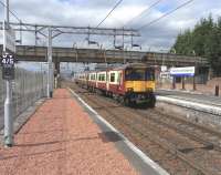 318 254 pulls into Platform 3 at Motherwell on 14 August on its rather convoluted route from Lanark to Dalmuir via the Hamilton Circle. These workings alternate with the direct services which leave Motherwell in the 'right' and opposite direction.The VT car stop sign is a bit of a red herring as this is not the main line and non-SPT services would only come via Hamilton during a rare diversion.<br><br>[David Panton 14/08/2010]