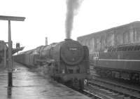 Britannia Pacific no 70038 <I>Robin Hood</I> waits in the rain at Carlisle in July 1964 ready to take out the 9.25am Crewe - Aberdeen.<br><br>[K A Gray 18/07/1964]