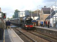 Ex-LMS 8F no 48151 enters Bamber Bridge over the level crossing on 4 August 2010 with the return working of <I>The Fellsman</I> weekly service from Lancaster to Carlisle via Preston, Blackburn and the Settle and Carlisle line. As can be seen from the activity at the east end of the platform there is quite a bit of local interest in this service.<br>
<br><br>[John McIntyre 04/08/2010]