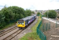 A Colne to Blackpool South stopping service in the hands of 142055 <br>
has just crossed the Accrington viaduct and is entering the station on 29 July 2010. The former route to Ramsbottom and the south used to follow the line of the newly created footpath on the right. The footpath has been built in connection with the new Tesco superstore.<br>
<br><br>[John McIntyre 29/07/2010]