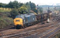 6833 heads up the Consett line past South Pelaw Junction on 20 August 1971 with what appear to be empty coal hoppers from Tyne Yard to one of the still working collieries on the line. (At that time the phrase 'taking coals to Newcastle' still had some resonance!)  The direct line to Tyne Dock passed through the extreme right hand span of the bridge in the background.<br>
<br><br>[Bill Jamieson 20/08/1971]